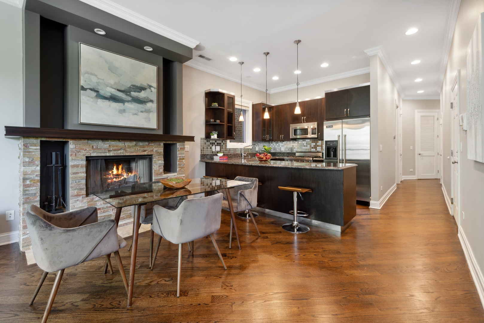 1131 West Addison Street, Unit 2 Chicago, IL 60613 - Photo 7 of 21 a dining room with furniture a rug and kitchen view