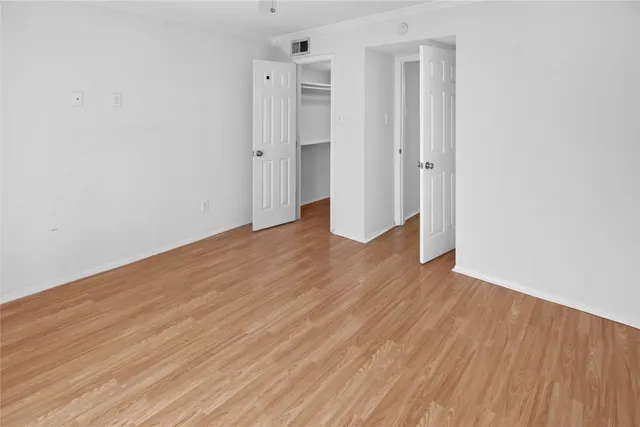 a view of a room with wooden floor and brick walls