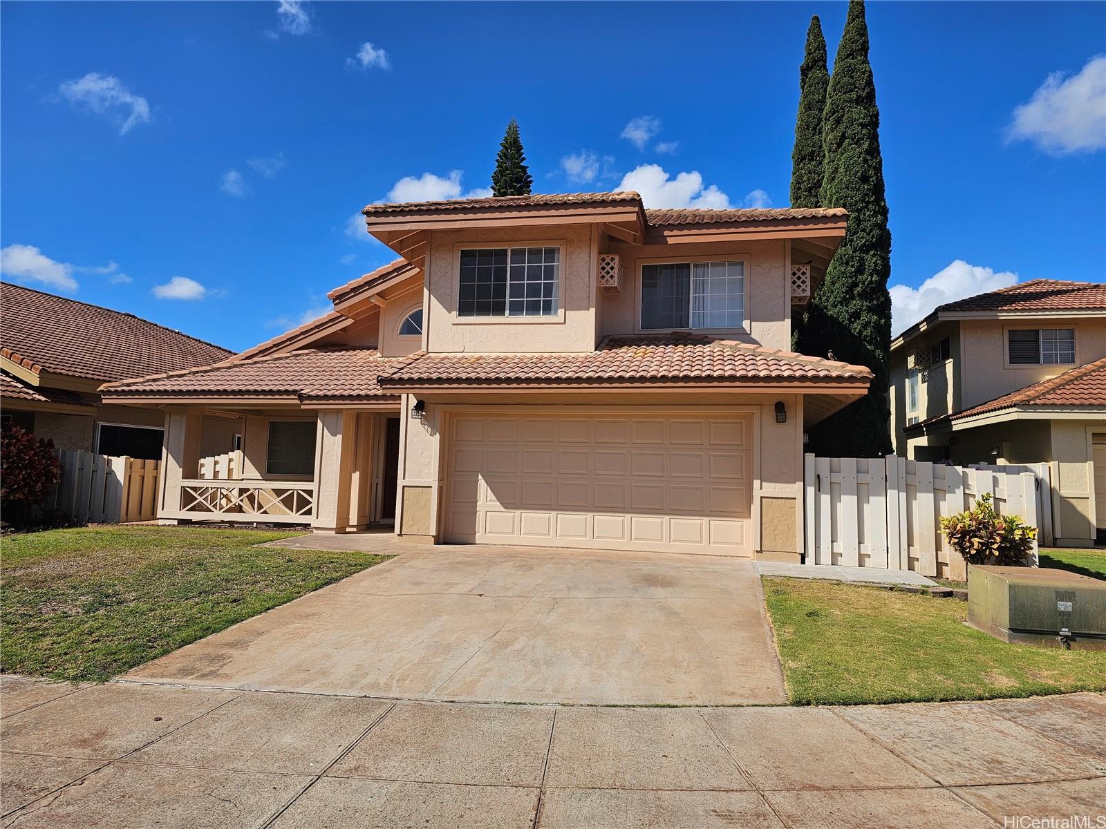 91-1040 Kanihaalilo Street Kapolei, HI 96707 - Photo 1 of 12 a front view of a house with a yard