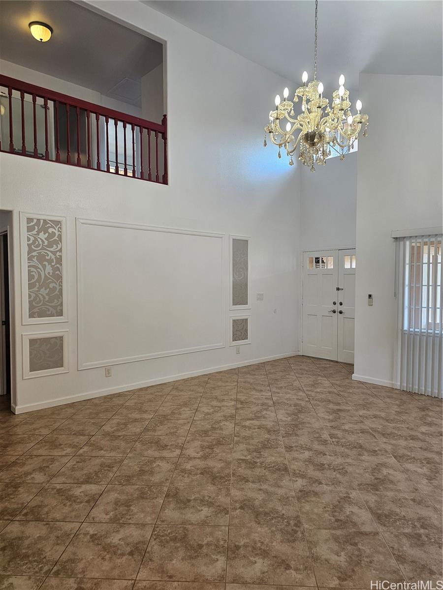91-1040 Kanihaalilo Street Kapolei, HI 96707 - Photo 3 of 12 a view of an empty room with chandelier fan and fire place