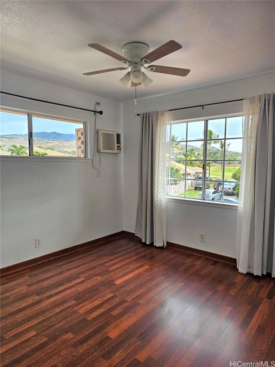 91-1040 Kanihaalilo Street Kapolei, HI 96707 - Photo 5 of 12 an empty room with wooden floor and windows
