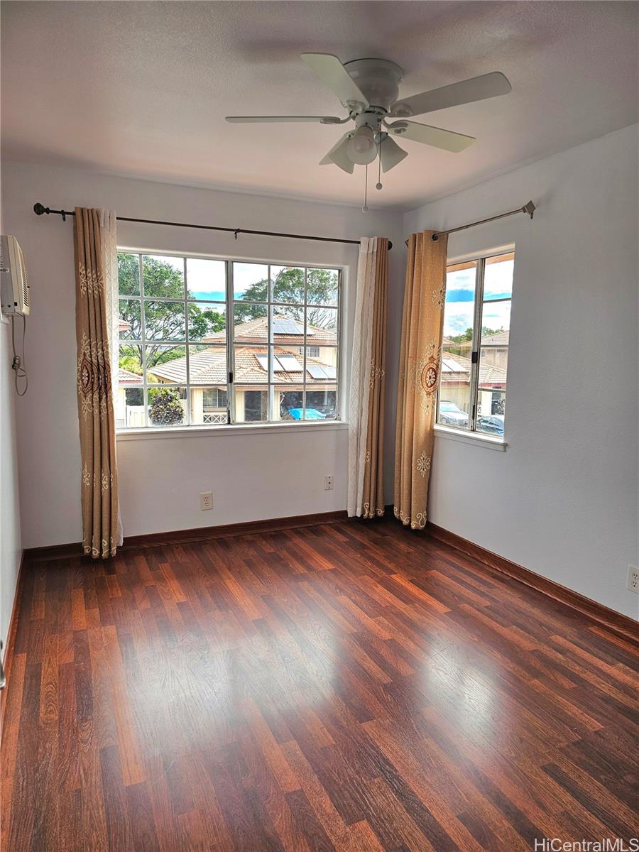91-1040 Kanihaalilo Street Kapolei, HI 96707 - Photo 6 of 12 a view of an empty room with wooden floor and a window