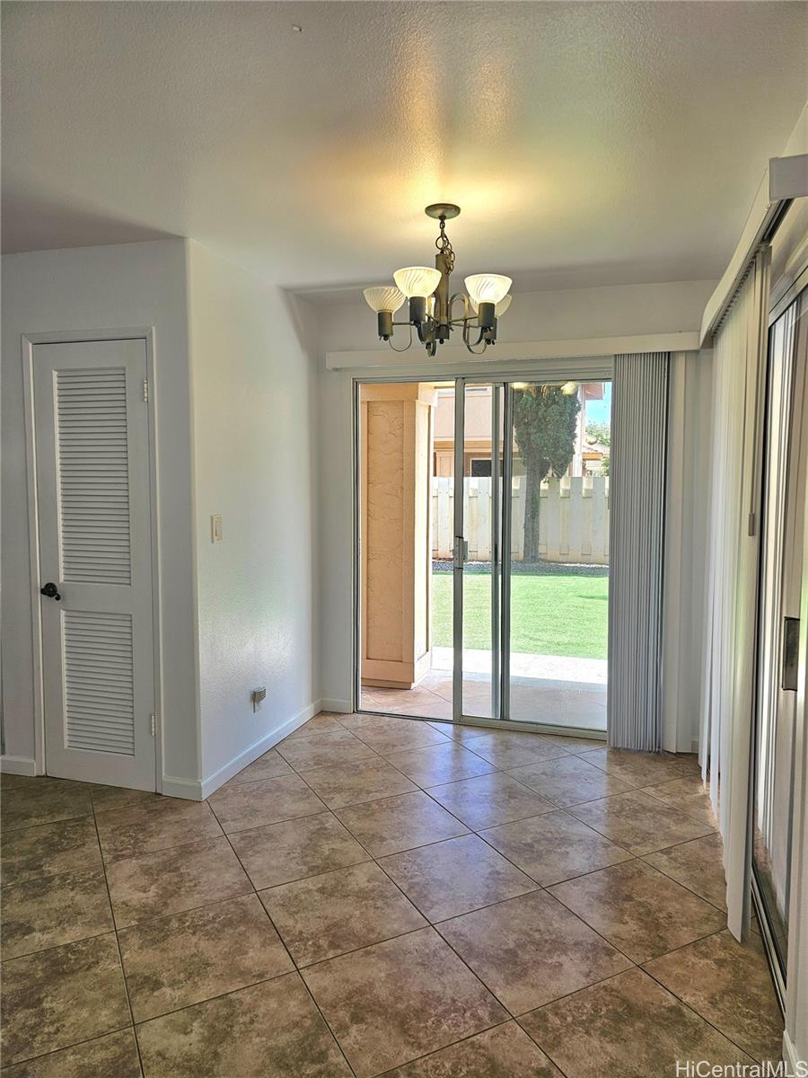 91-1040 Kanihaalilo Street Kapolei, HI 96707 - Photo 8 of 12 wooden floor in an empty room with a window