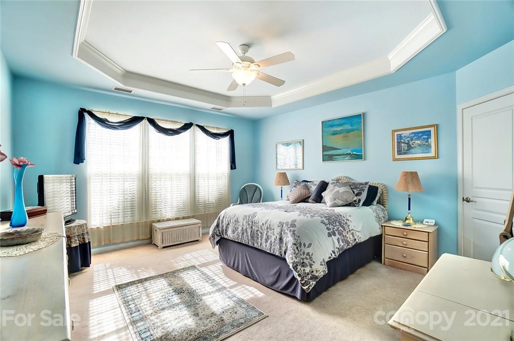 2135 Ashley River Road Waxhaw, NC 28173 - Photo 12 of 17 a spacious bedroom with a bed a window and a mirror