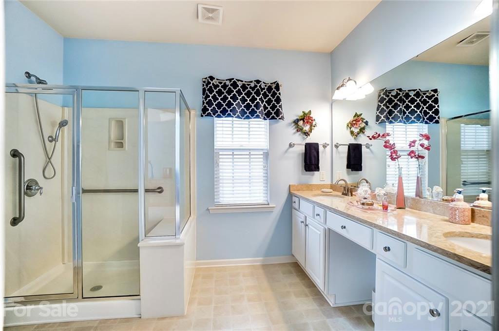 2135 Ashley River Road Waxhaw, NC 28173 - Photo 13 of 17 a bathroom with a double vanity sink mirror and shower