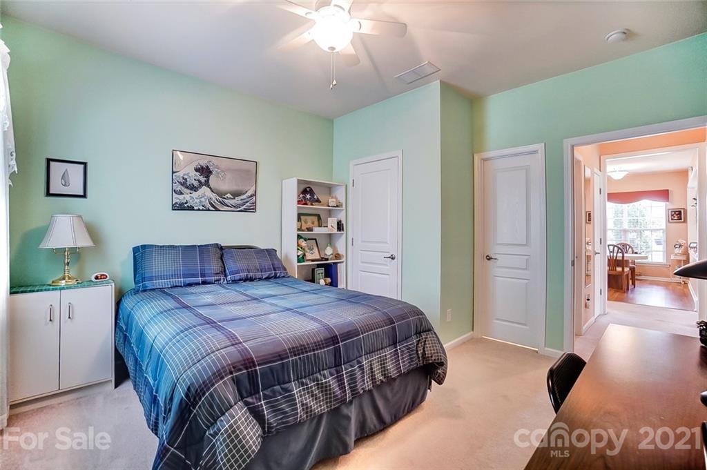 2135 Ashley River Road Waxhaw, NC 28173 - Photo 14 of 17 a bedroom with a large bed and a chandelier