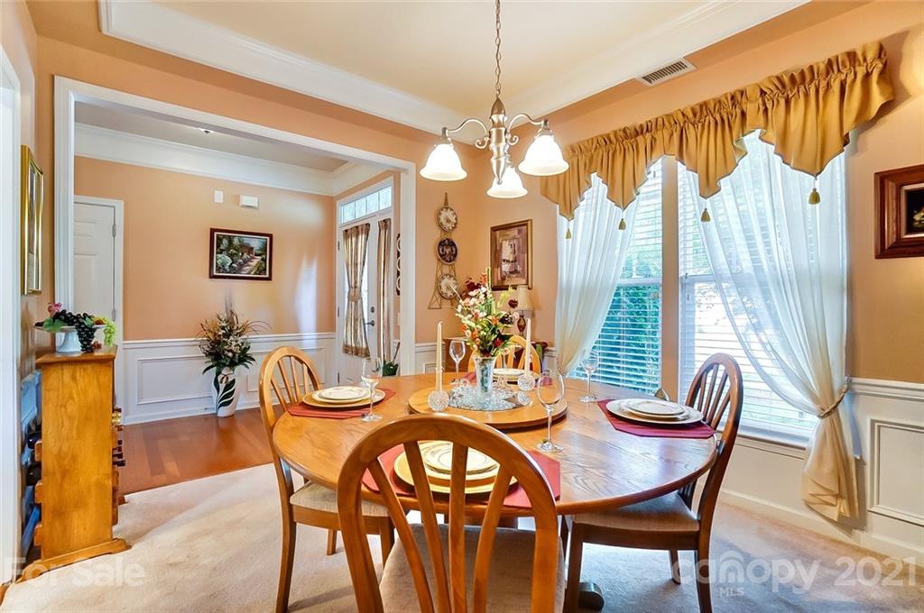 2135 Ashley River Road Waxhaw, NC 28173 - Photo 3 of 17 a view of a dining room with furniture and a chandelier