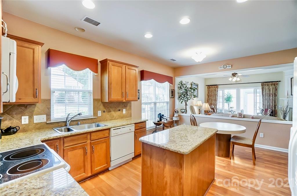 2135 Ashley River Road Waxhaw, NC 28173 - Photo 4 of 17 a kitchen with a stove a sink and a refrigerator