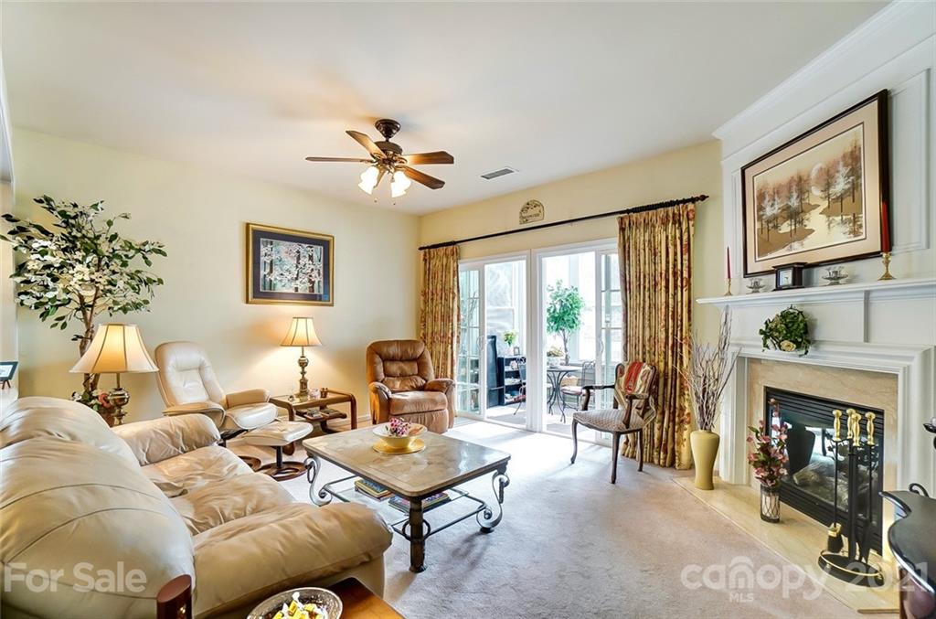 2135 Ashley River Road Waxhaw, NC 28173 - Photo 7 of 17 a living room with furniture a large window and a fireplace