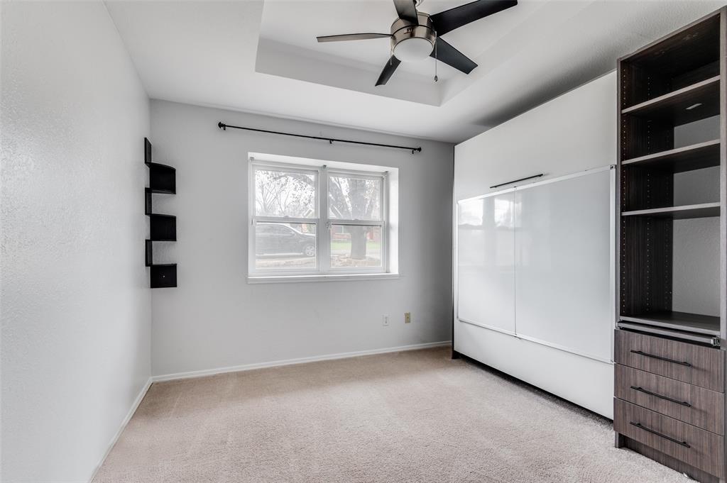 2749 Buna Drive Dallas, TX 75211 - Photo 9 of 12 Bedroom with Murphy bed, a ceiling fan, a raised ceiling, and light carpet