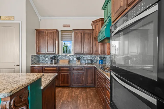 a bathroom with a double vanity sink a toilet a mirror and bathtub
