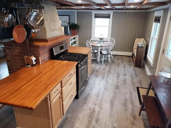 206 Blackmore Pond Road Wareham, MA 02576 - Photo 8 of 23 a dining room with wooden floor and furniture