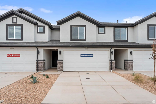 2185 Wolverine Way, Unit 2454 Washington, UT 84780 - Photo 1 of 1 View of front of house with stucco siding, stone siding, an attached garage, driveway, and a tile roof