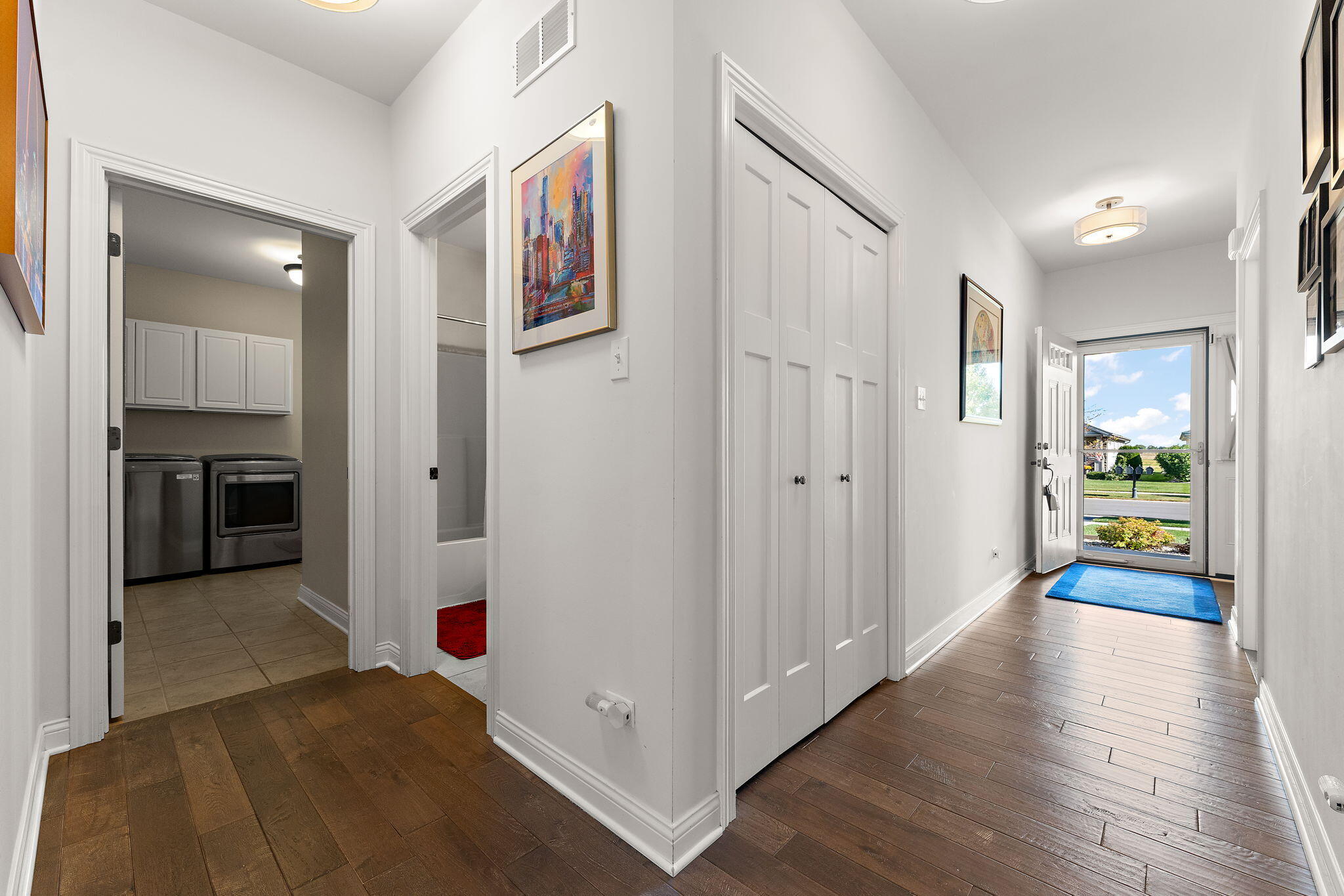 10138 Privet Drive Crown Point, IN 46307 - Photo 18 of 39 a view of a hallway with wooden floor and furniture