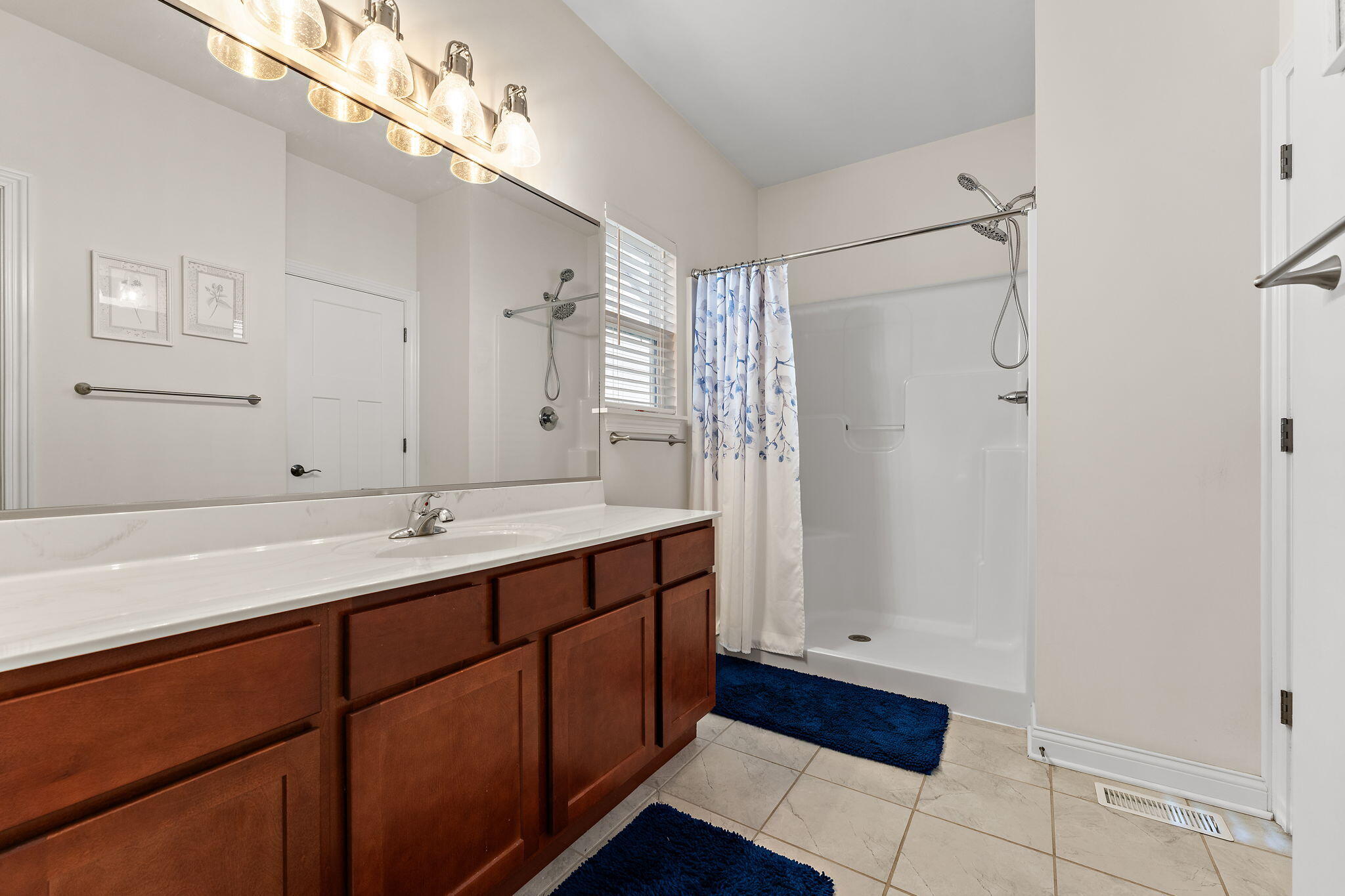 10138 Privet Drive Crown Point, IN 46307 - Photo 20 of 39 a bathroom with a double vanity sink and mirror