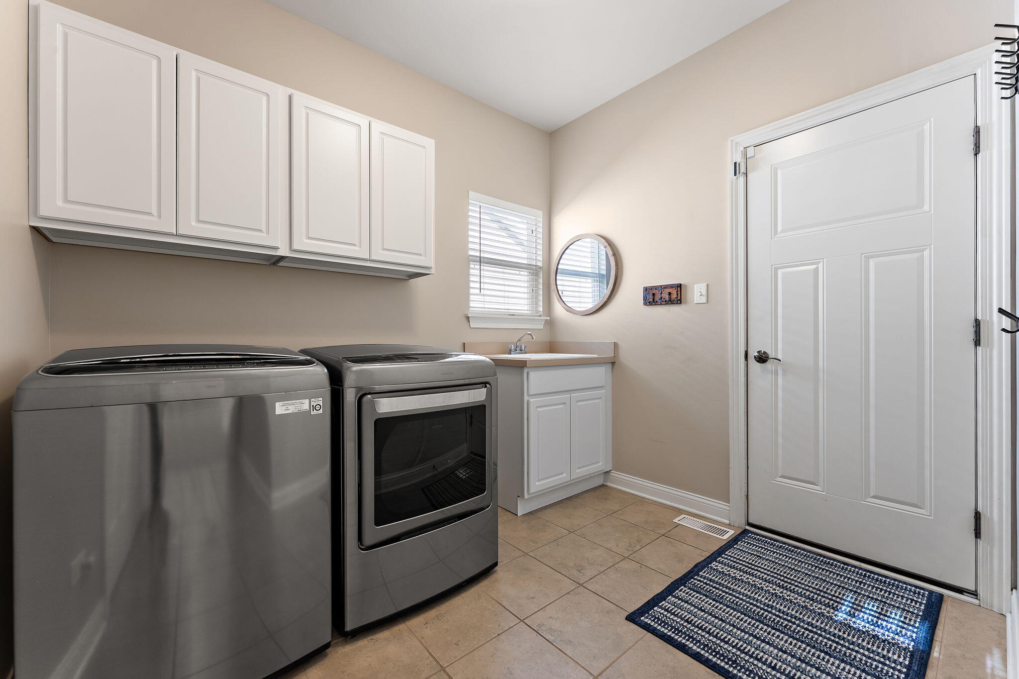 10138 Privet Drive Crown Point, IN 46307 - Photo 24 of 39 a utility room with cabinets washer and dryer