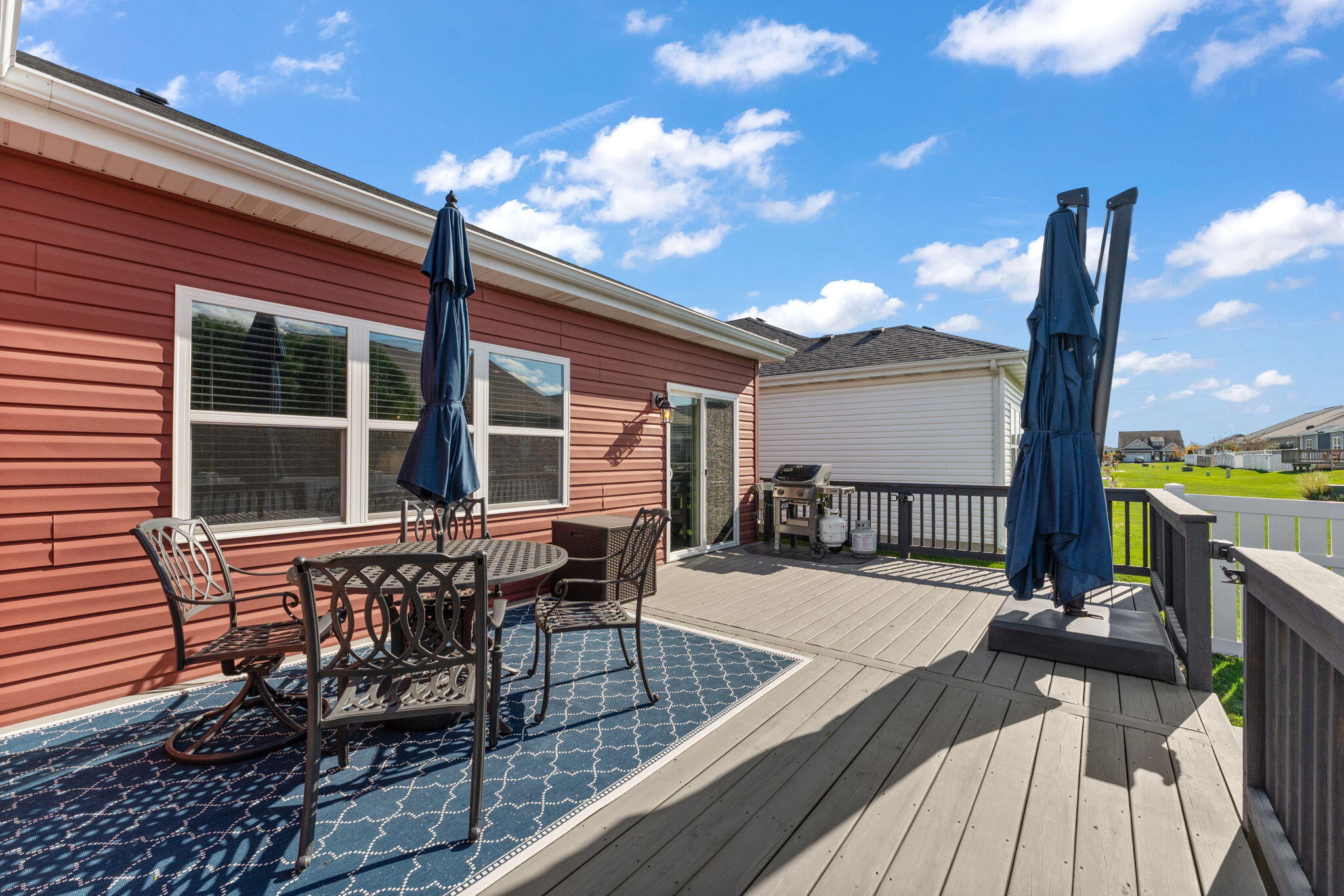 10138 Privet Drive Crown Point, IN 46307 - Photo 28 of 39 a view of a roof deck with table and chairs with wooden floor and fence
