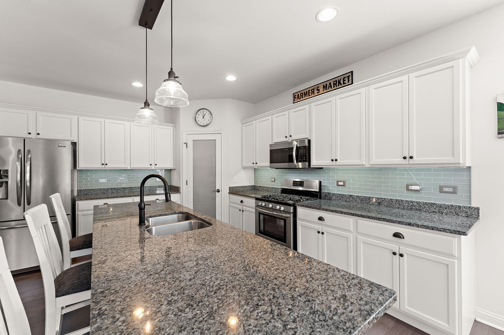 10138 Privet Drive Crown Point, IN 46307 - Photo 3 of 39 a kitchen with stainless steel appliances granite countertop a sink a stove a refrigerator cabinets and chairs