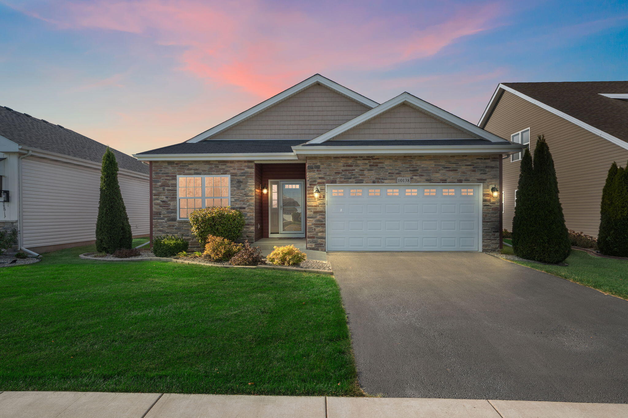 10138 Privet Drive Crown Point, IN 46307 - Photo 37 of 39 a front view of a house with a yard and garage