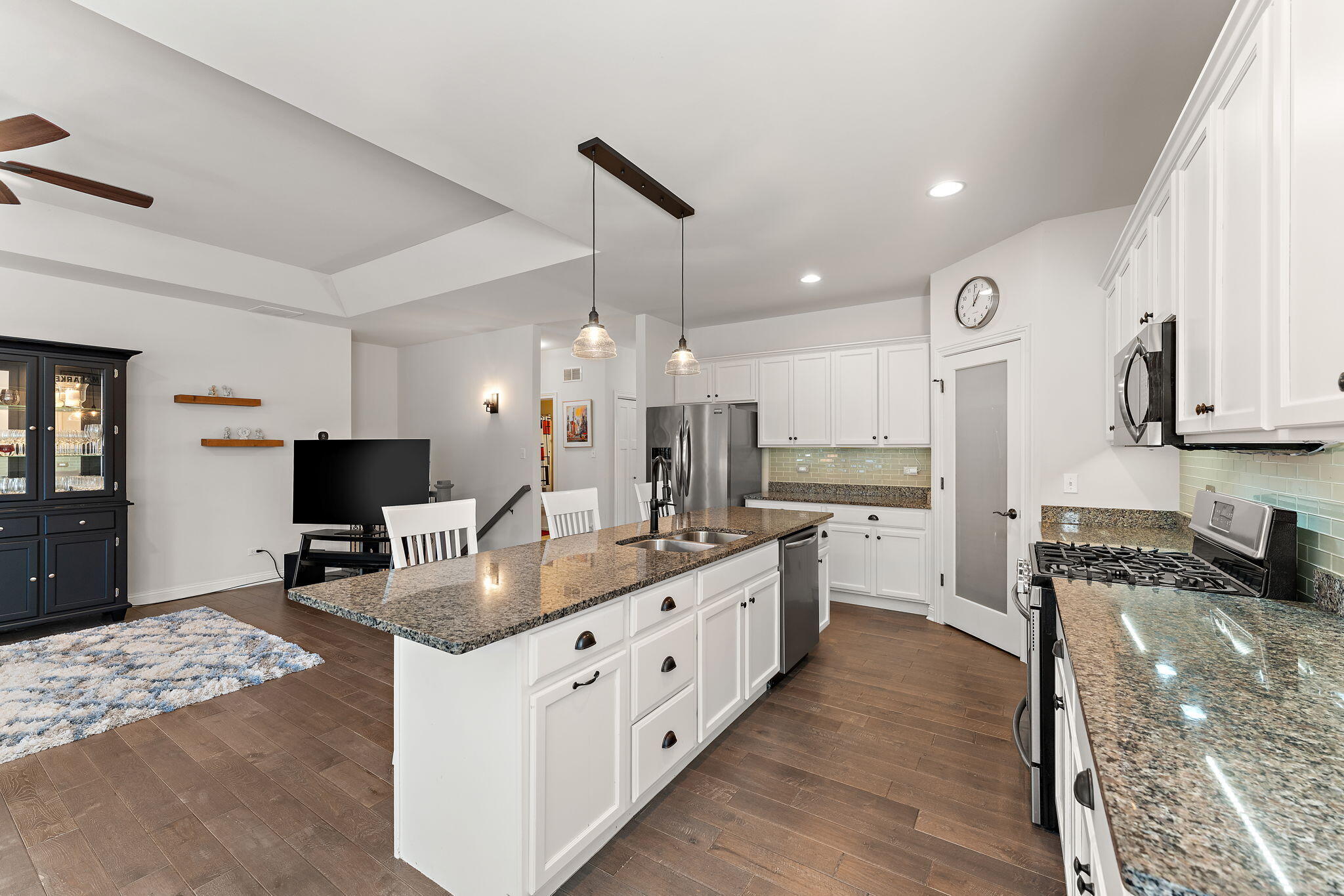 10138 Privet Drive Crown Point, IN 46307 - Photo 6 of 39 a large kitchen with stainless steel appliances granite countertop a lot of counter space and wooden floor