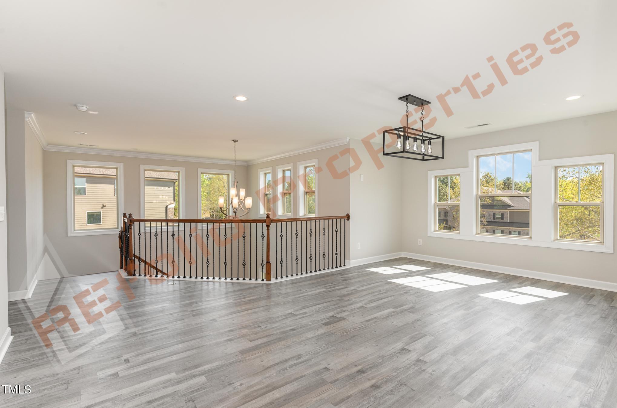 1001 Covered Bridge Trail Chapel Hill, NC 27517 - Photo 14 of 41 a view of an empty room with wooden floor and windows