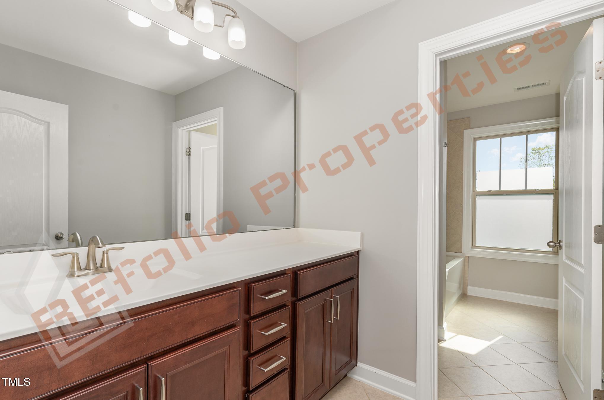 1001 Covered Bridge Trail Chapel Hill, NC 27517 - Photo 19 of 41 a bathroom with a sink a vanity and a mirror