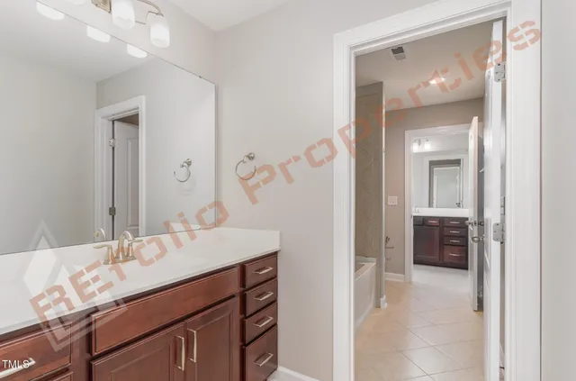 a bathroom with a sink vanity and mirror