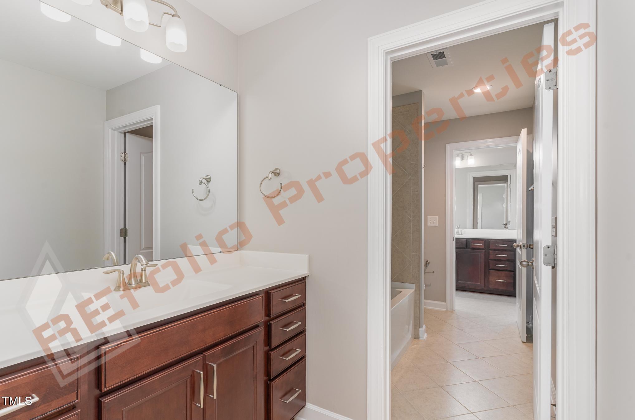 1001 Covered Bridge Trail Chapel Hill, NC 27517 - Photo 23 of 41 a bathroom with a sink vanity and mirror