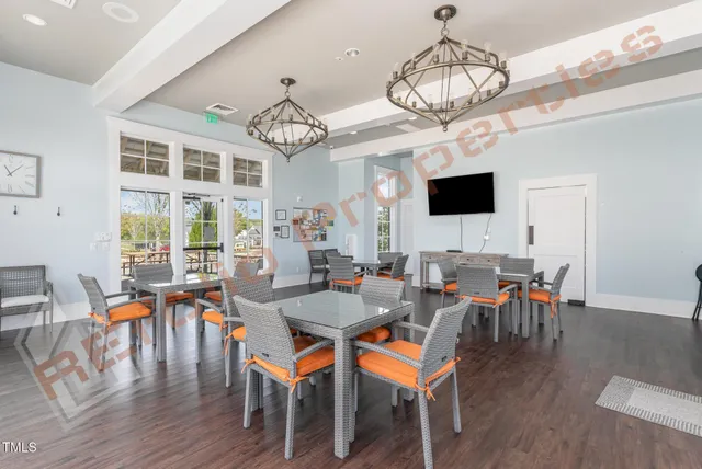 a view of a dining room with furniture wooden floor and chandelier