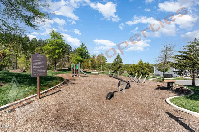 a view of a park with iron fence