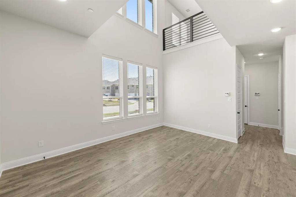 3900 Keya Drive Prosper, TX 75078 - Photo 14 of 36 an empty room with wooden floor and windows