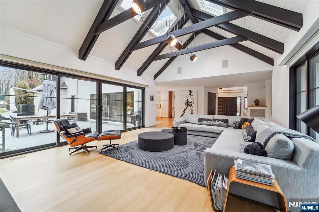 58 Twin Brooks Road Saddle River, NJ 07458 - Photo 12 of 45 a living room with furniture and floor to ceiling windows