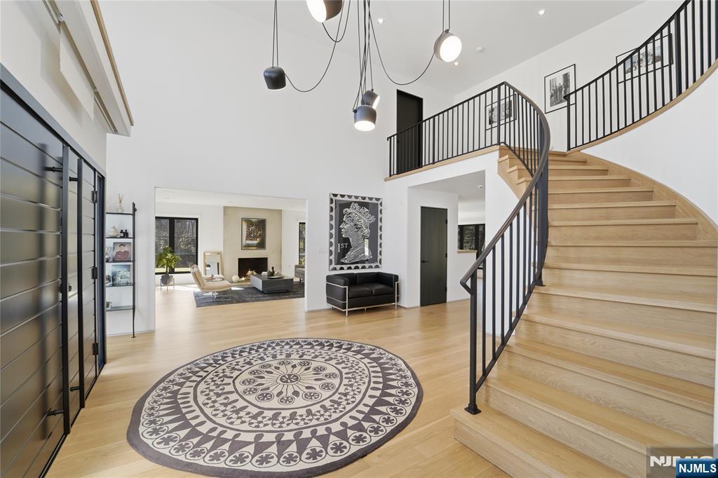 58 Twin Brooks Road Saddle River, NJ 07458 - Photo 6 of 45 a view of a livingroom with wooden floor and a fireplace