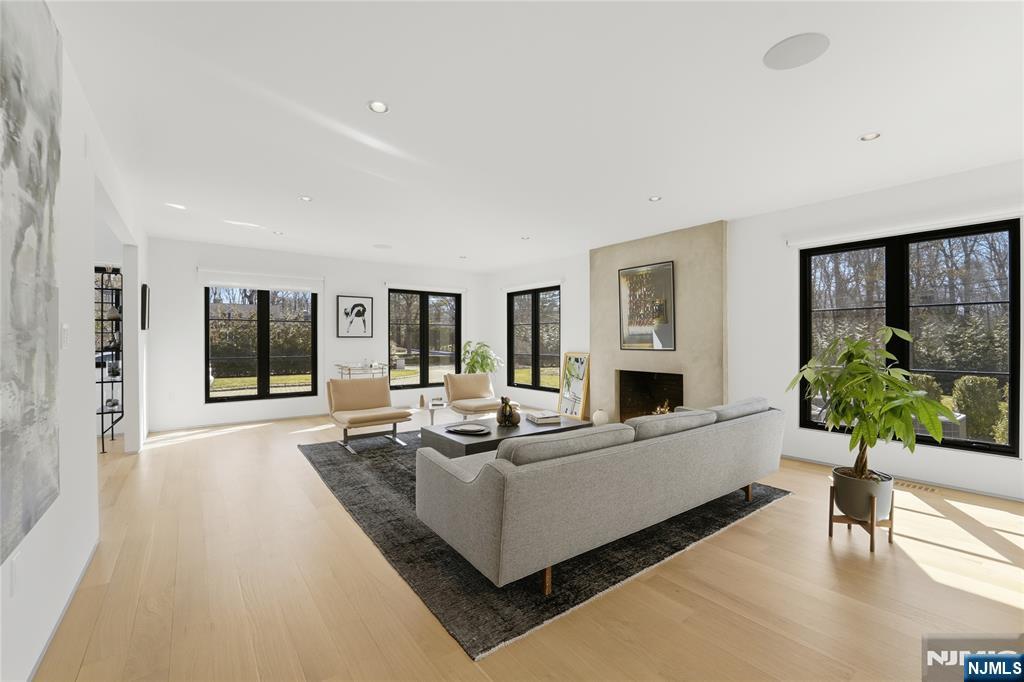 58 Twin Brooks Road Saddle River, NJ 07458 - Photo 8 of 45 a living room with furniture large window and a flat screen tv