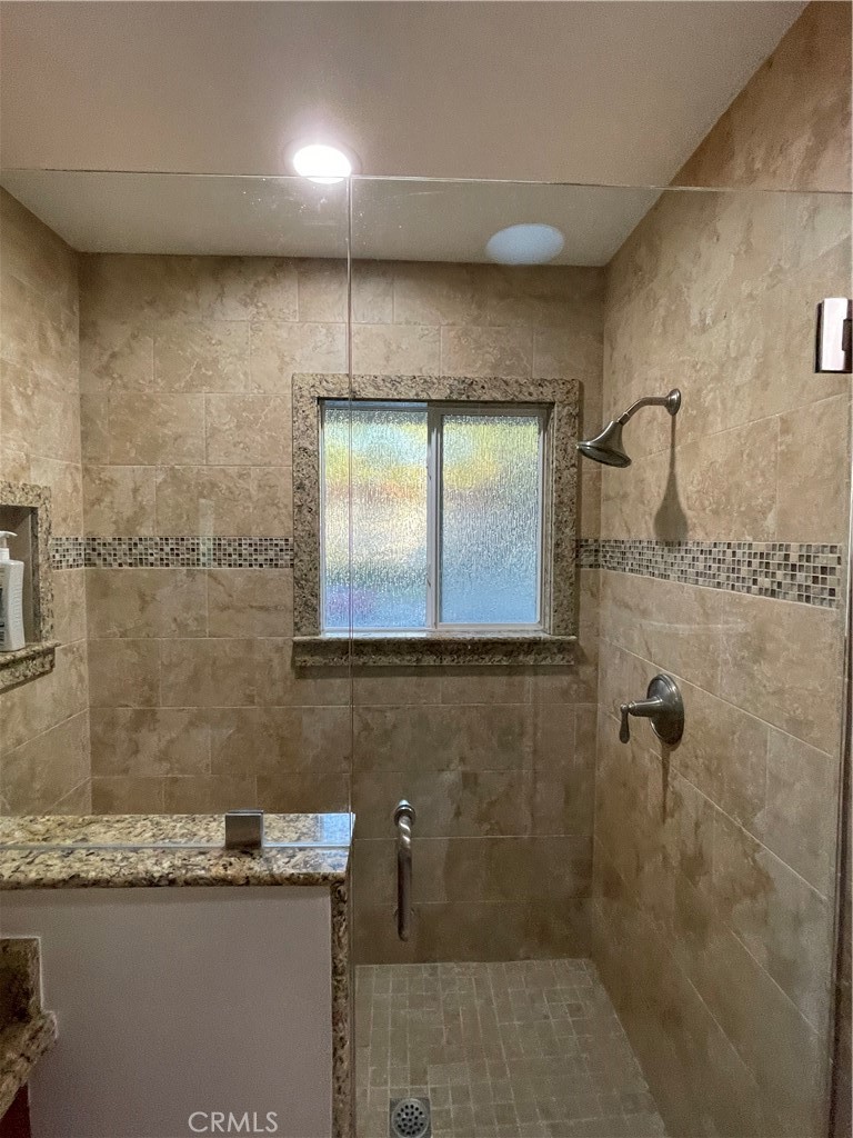 662 Via Los Altos, Unit P Laguna Woods, CA 92637 - Photo 15 of 46 a bathroom with a granite countertop sink a toilet and mirror