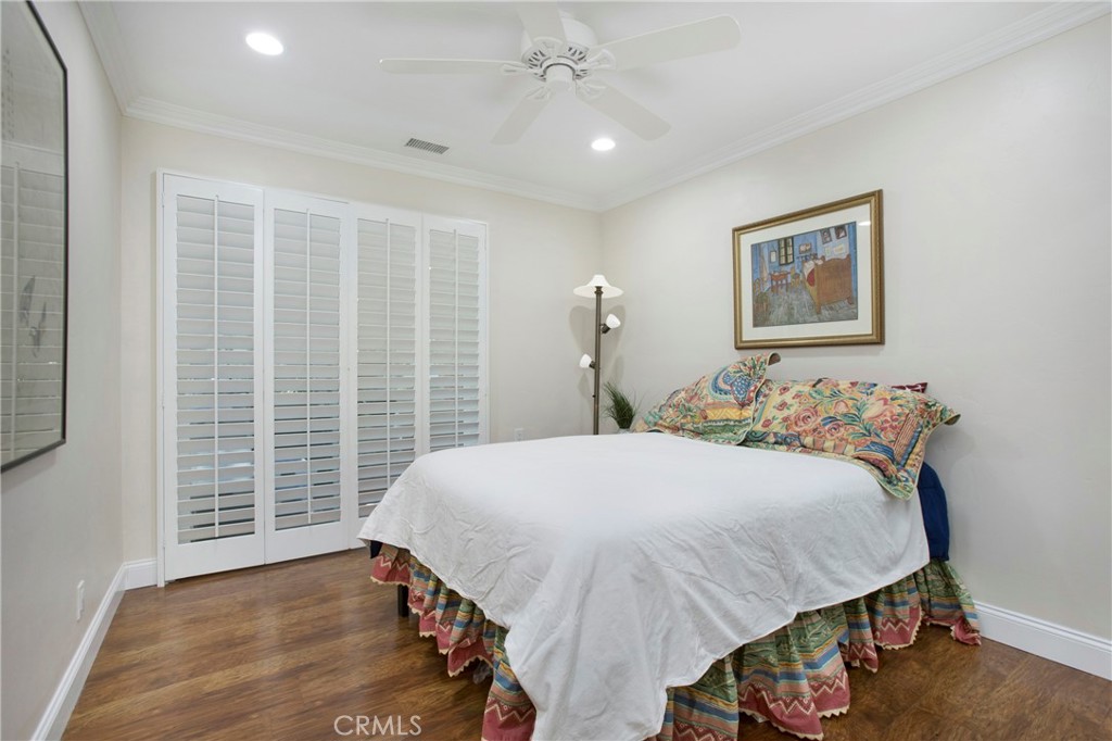 662 Via Los Altos, Unit P Laguna Woods, CA 92637 - Photo 16 of 46 a bedroom with a bed and a table with closet