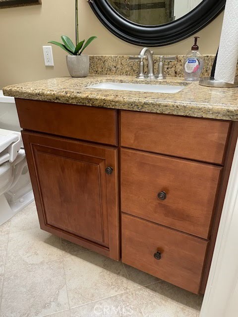 662 Via Los Altos, Unit P Laguna Woods, CA 92637 - Photo 18 of 46 a bathroom with a granite countertop sink and mirror