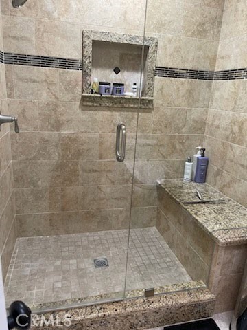 662 Via Los Altos, Unit P Laguna Woods, CA 92637 - Photo 19 of 46 a bathroom with a granite countertop shower a sink and a mirror
