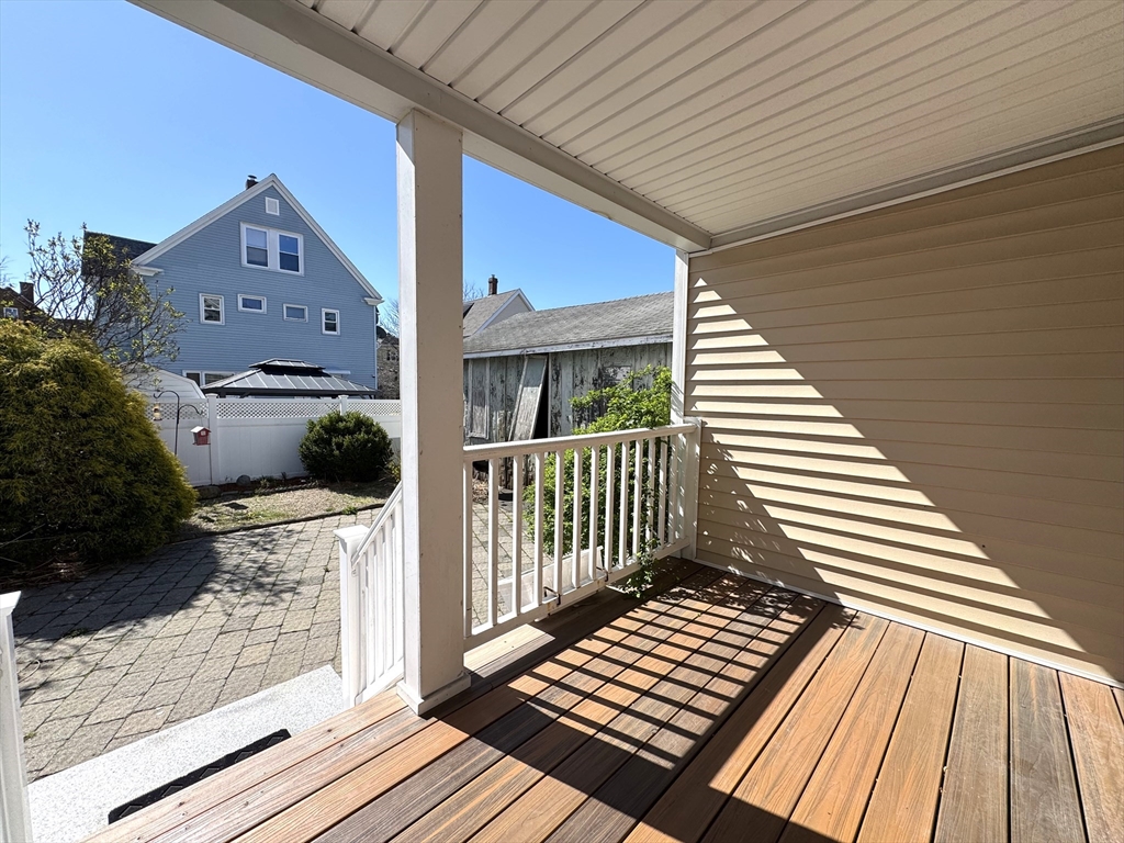 69 Cleveland Avenue, Unit 1 Everett, MA 02149 - Photo 11 of 13 a view of a wooden deck with a bench