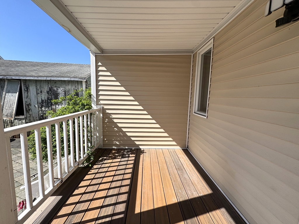 69 Cleveland Avenue, Unit 1 Everett, MA 02149 - Photo 12 of 13 a view of balcony with wooden floor