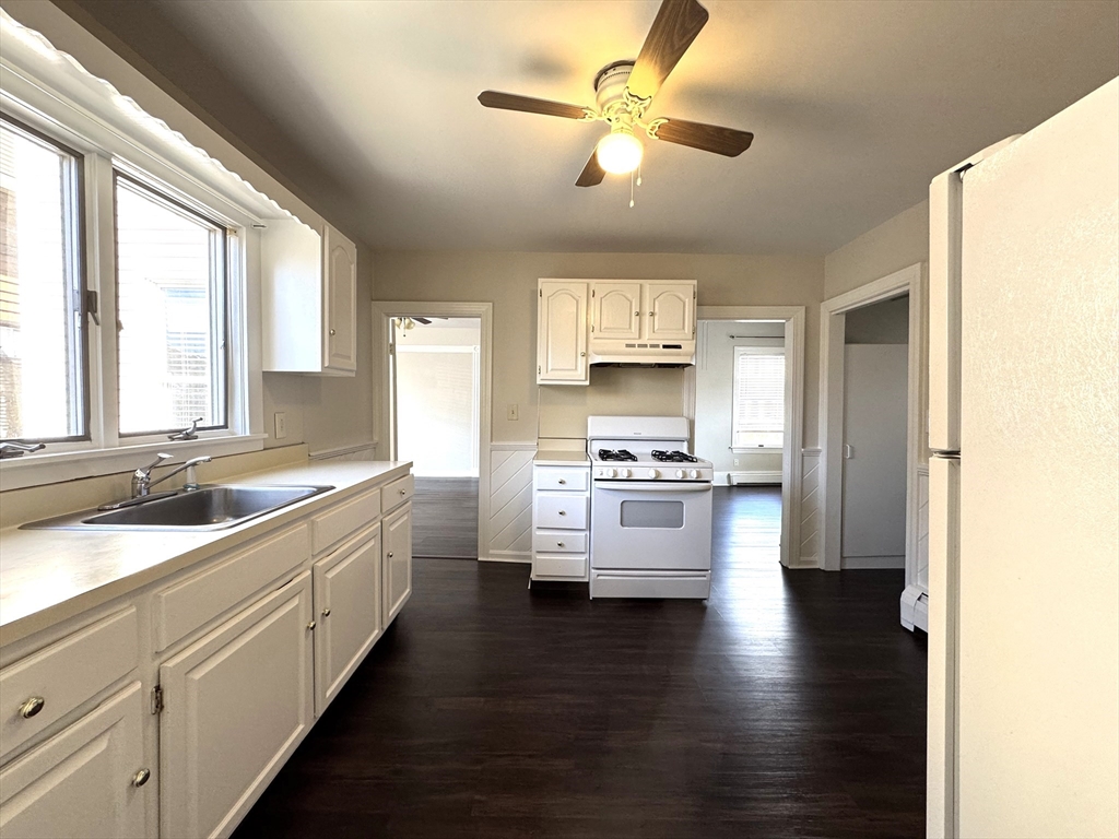 69 Cleveland Avenue, Unit 1 Everett, MA 02149 - Photo 2 of 13 a large kitchen with stainless steel appliances a large window and a sink