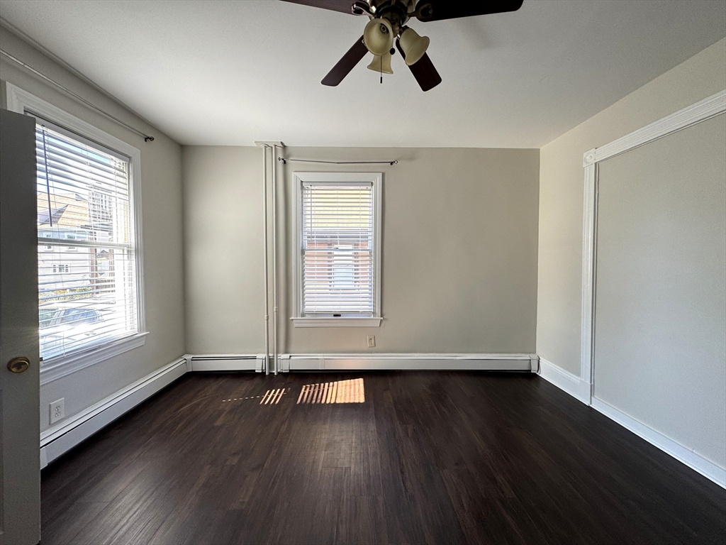 69 Cleveland Avenue, Unit 1 Everett, MA 02149 - Photo 7 of 13 a view of wooden floor and windows in a room