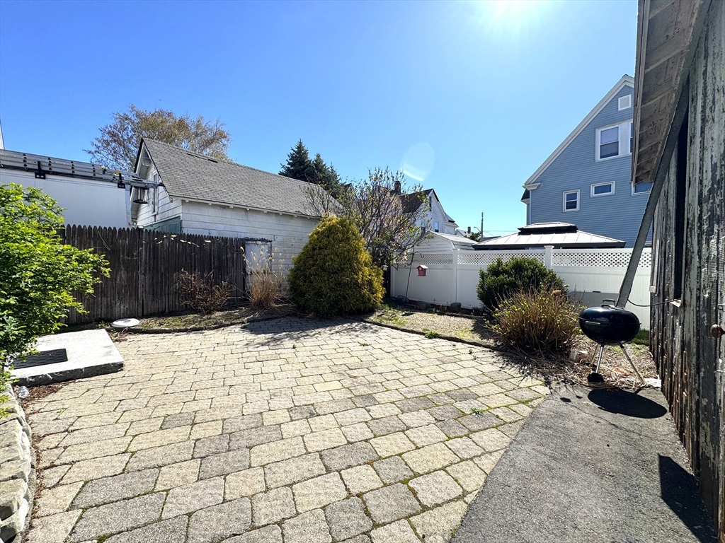 69 Cleveland Avenue, Unit 1 Everett, MA 02149 - Photo 9 of 13 a view of a house with a bench in a patio
