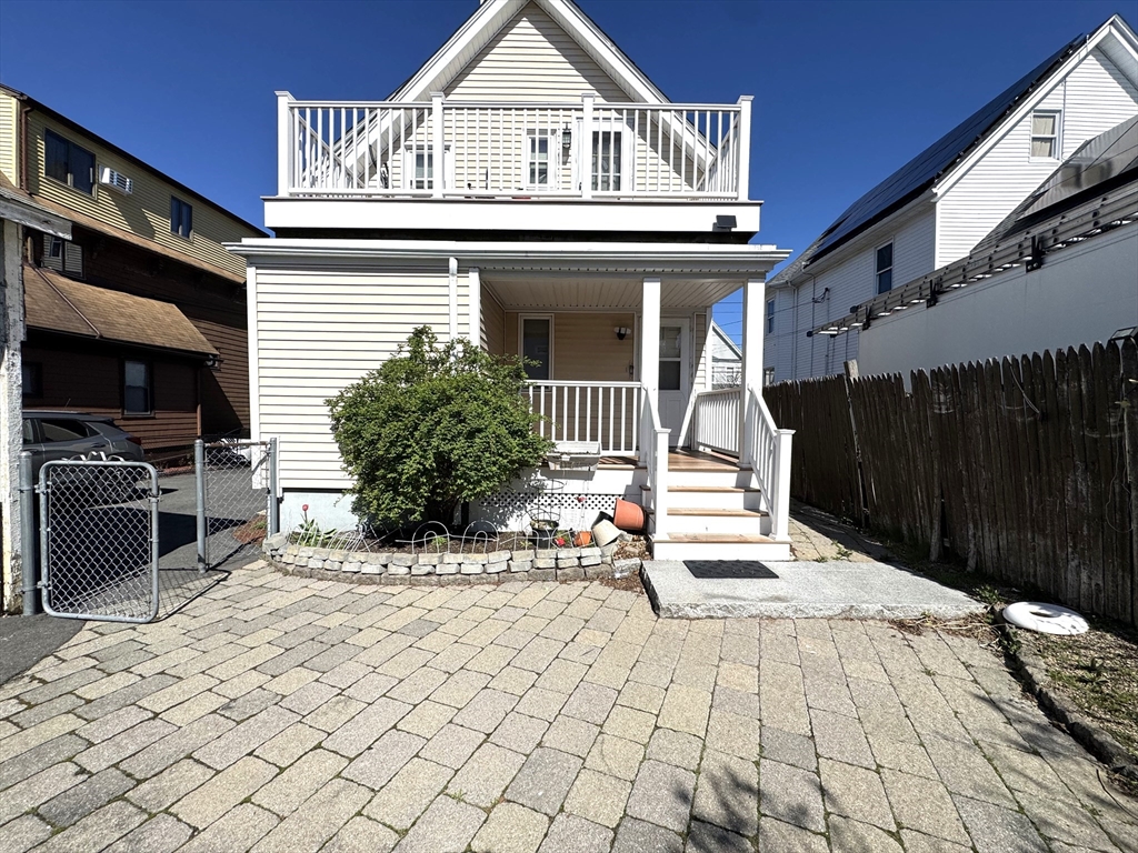 69 Cleveland Avenue, Unit 1 Everett, MA 02149 - Photo 10 of 13 a view of a patio with table and chairs with wooden floor and fence