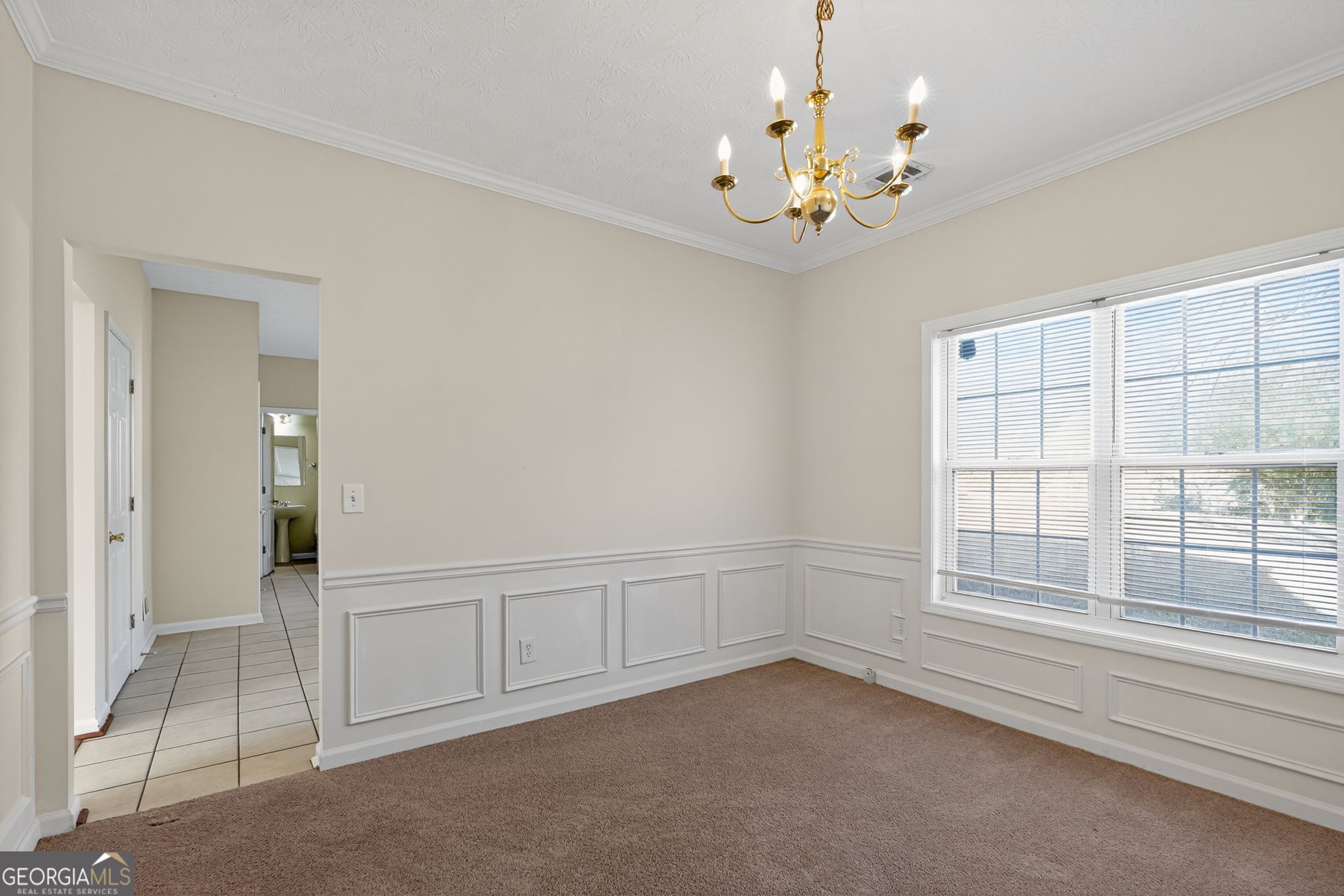 3812 Walnut Path Lithonia, GA 30038 - Photo 14 of 37 an empty room with chandelier and windows