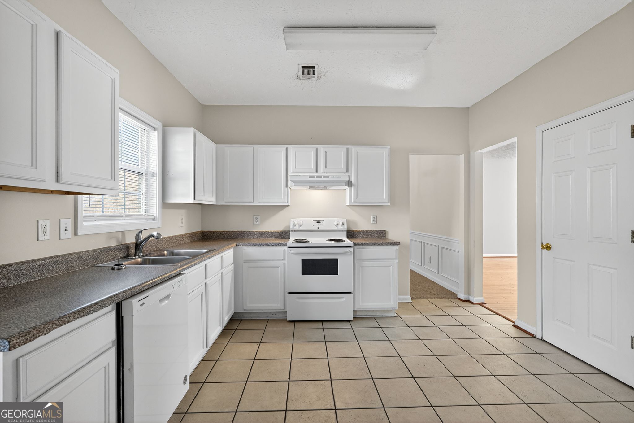 3812 Walnut Path Lithonia, GA 30038 - Photo 16 of 37 a kitchen with a stove sink and cabinets
