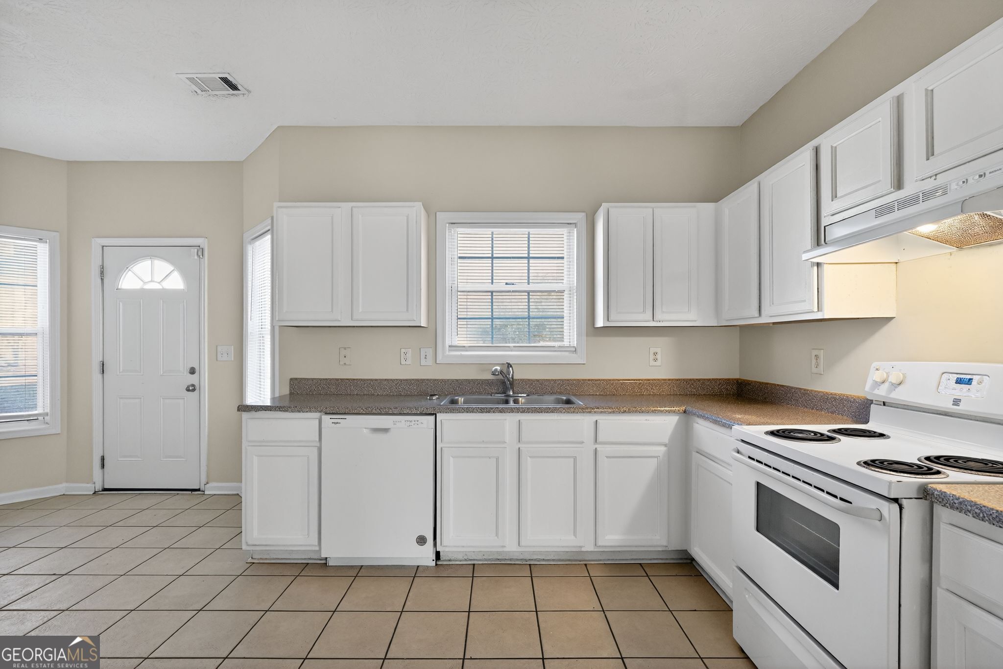 3812 Walnut Path Lithonia, GA 30038 - Photo 18 of 37 a kitchen with granite countertop white cabinets and white appliances