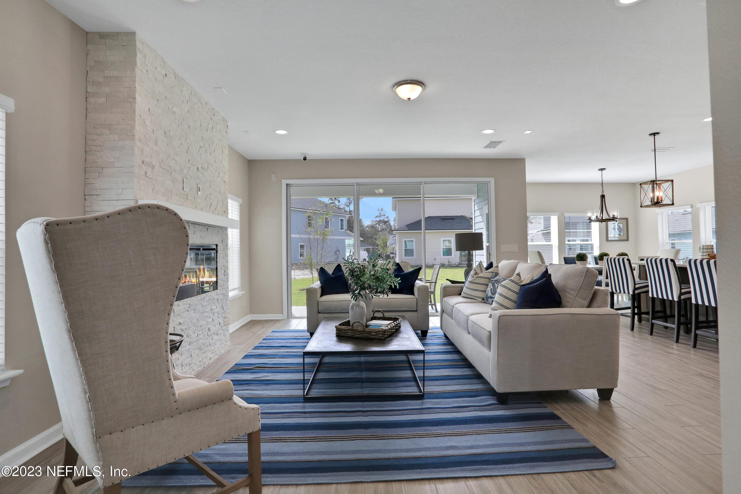 190 Bluegrass Way St. Augustine, FL 32092 - Photo 6 of 58 a living room with furniture and a potted plant