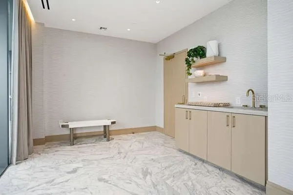 a living room with furniture a flat screen tv a rug and a mirror