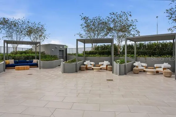 a patio with water view fountain and a potted plant